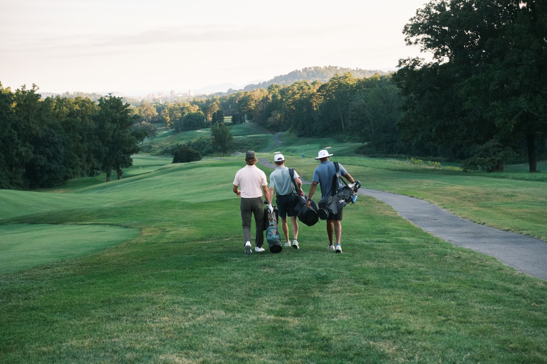 Three golfers walking the fairway at a Smoky Mountain Shootout course