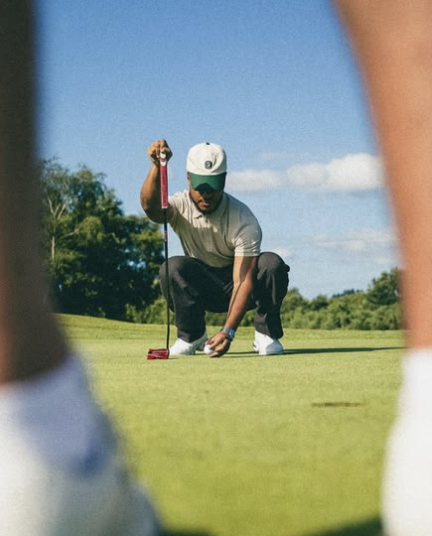 Golfer lining up a putt on a mountain course